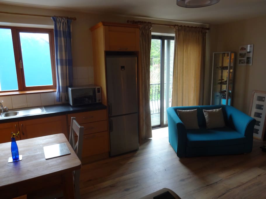 The open plan living, kitchen and dining room is ideal for a night in with friends.