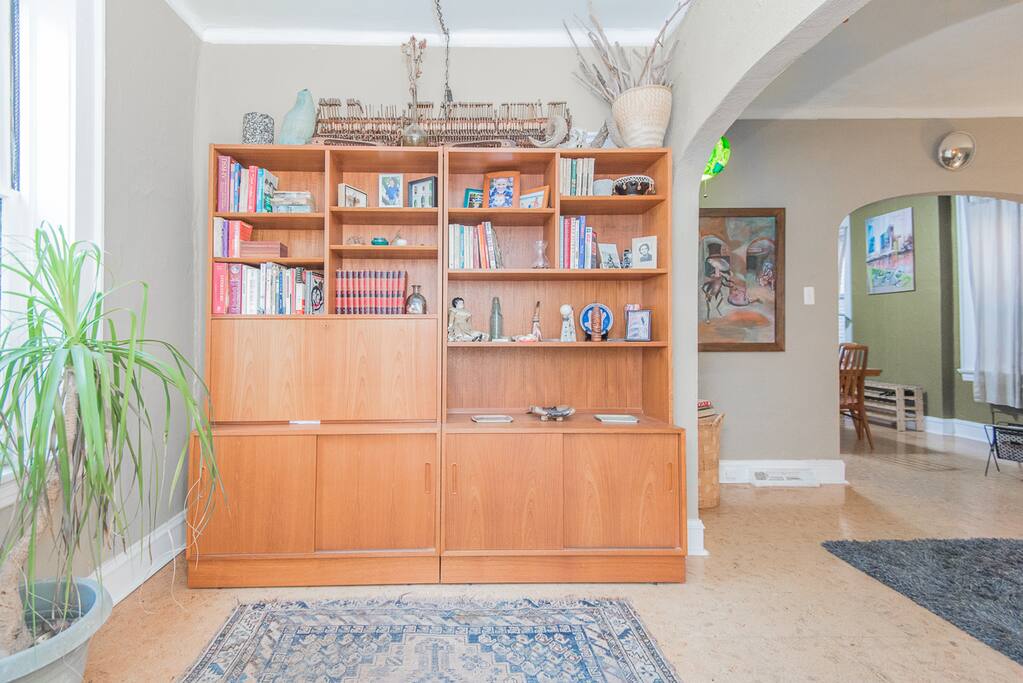 Foyer library featuring Hundevad casegoods and the artwork of Eric Larimore peaking out from the living room