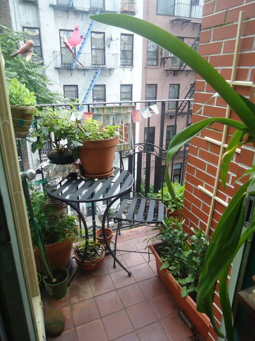 Balcony overlooking quiet backyard. Bistro table perfect for morning coffee and the paper!