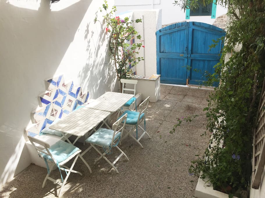 The sheltered blooming garden can guest dining for 8