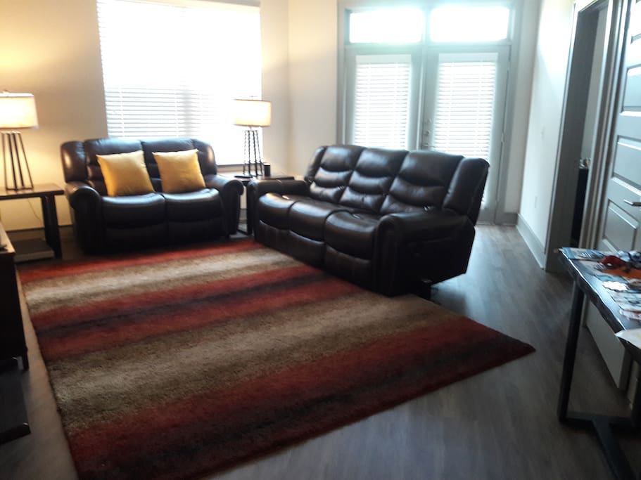 Living room with electric, reclining couch and love seat