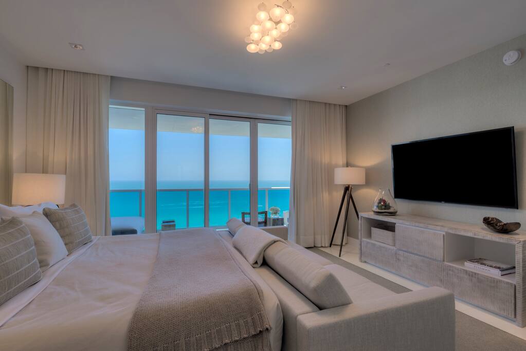 Master bedroom with private balcony, king bed