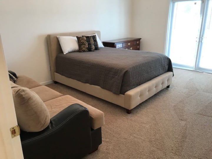 Third large bedroom with queen bed, large couch, generous closet and drawers