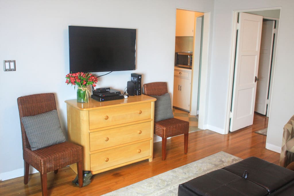 Living room has a Smart TV with cable