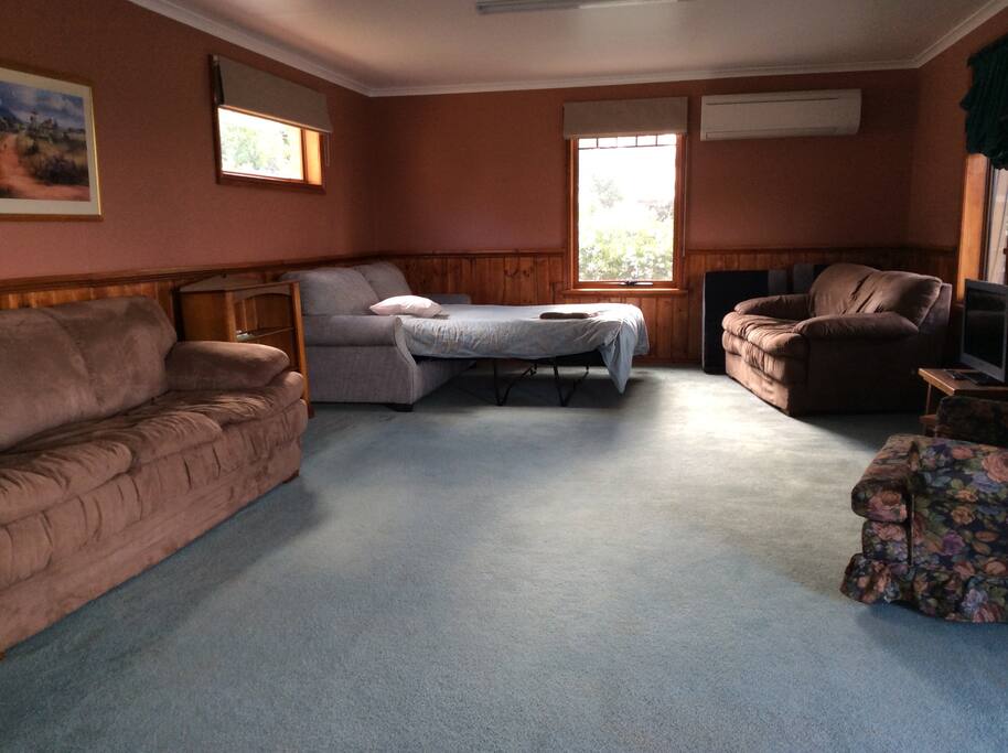 Sofa bed in comfy living area with flat screen tv