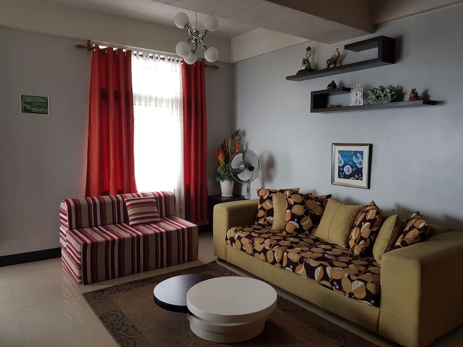 Living room area:
- Couch
- Sofa Bed
- Electric Fan
- Coffee Table