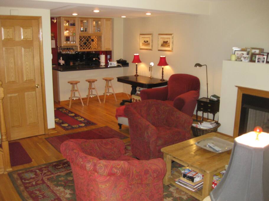 View of living area from outside entrance with kitchen in background, Home has central air and heat.