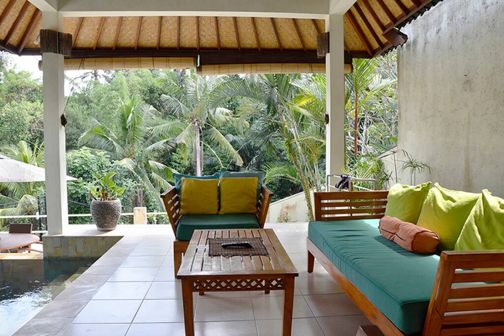 The living room is open to views, the pool and dining area.