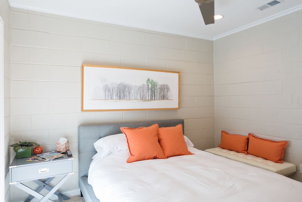 The Casita bedroom with sun shining through the sliding glass door.