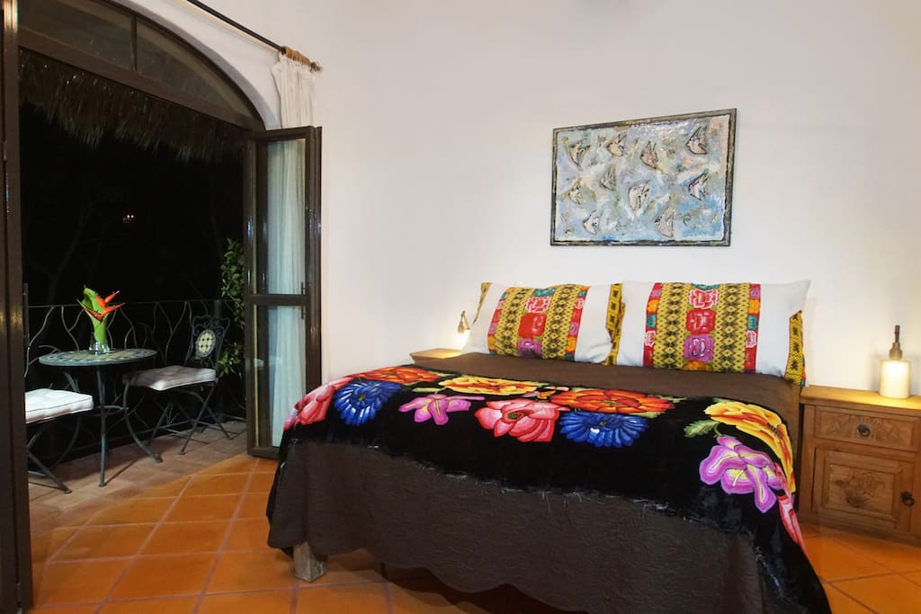 Bedroom opens up to balcony.