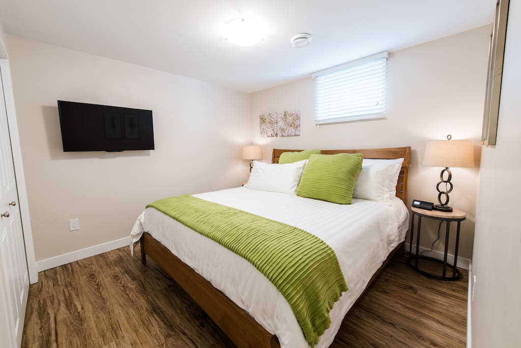 Bedroom #2 with king bed and 39" Roku TV on a swivel mount. Watch TV while lying in the comfy bed.