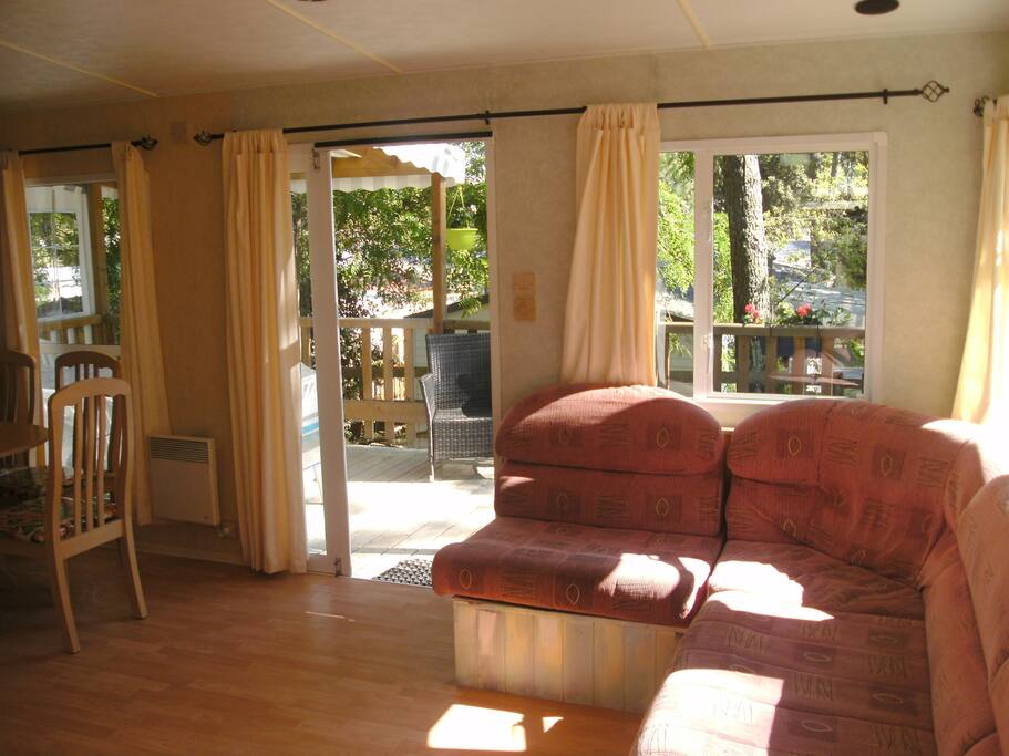 French style doors which open from the lounge on to the covered balcony. Table and seating is also outside.