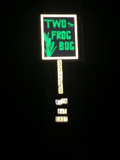 This is the sign at beginning of driveway, as seen at night.
