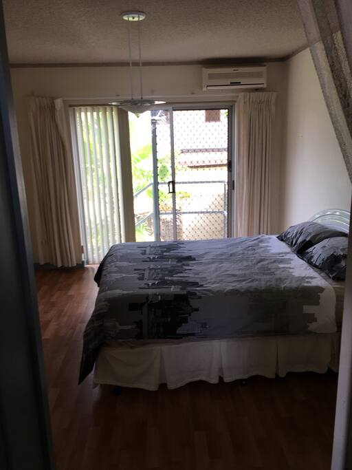 Spacious bedroom backdoor leads to laundry access .