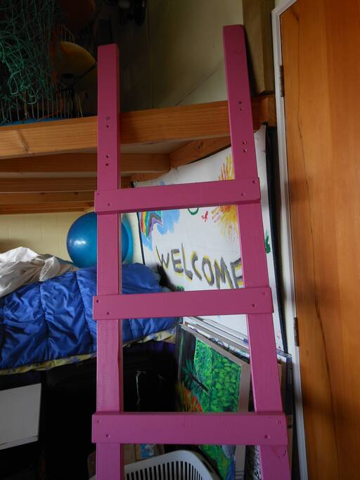 Pink ladder to the fairy bed in the basement with garage door that opens to lovely views