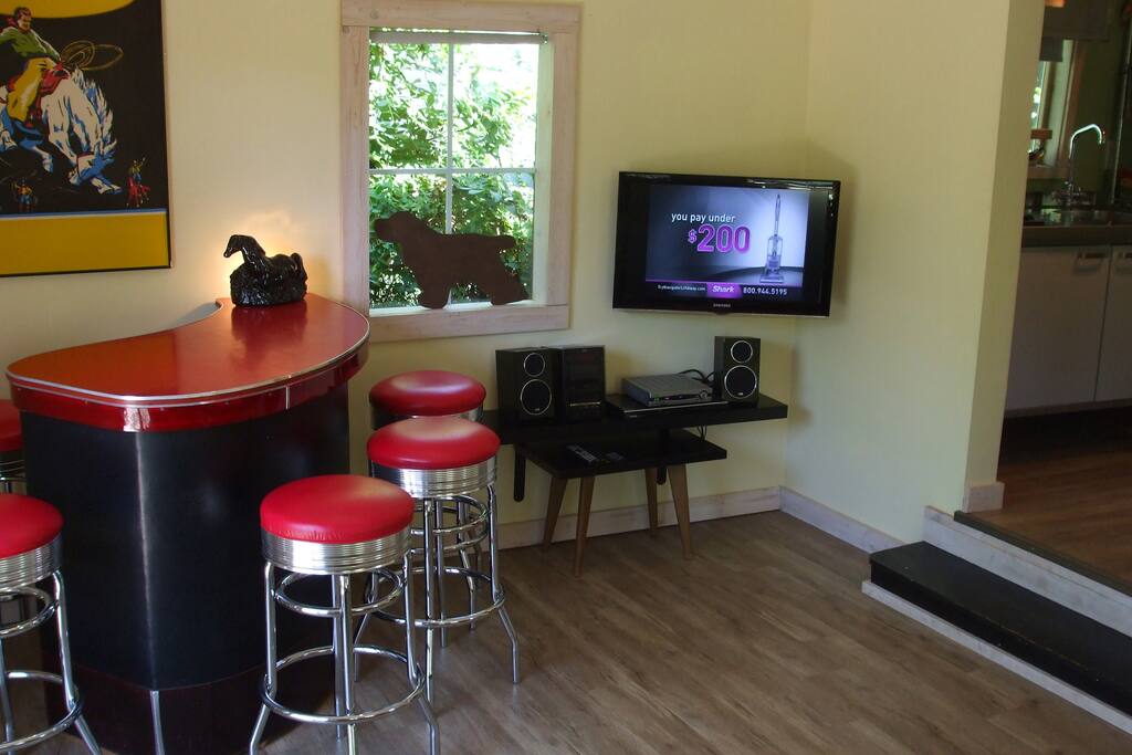 Half of the living room with HD TV, Stereo with Ipod player and bar