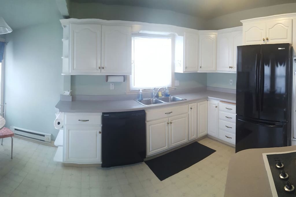Kitchen with small breakfast nook.
Plates, flatware, cups, utensils, pots, pans, stove, oven, microwave, toaster, and fridge available for use.