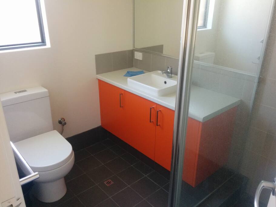 Bathroom has a shower, toilet and vanity
