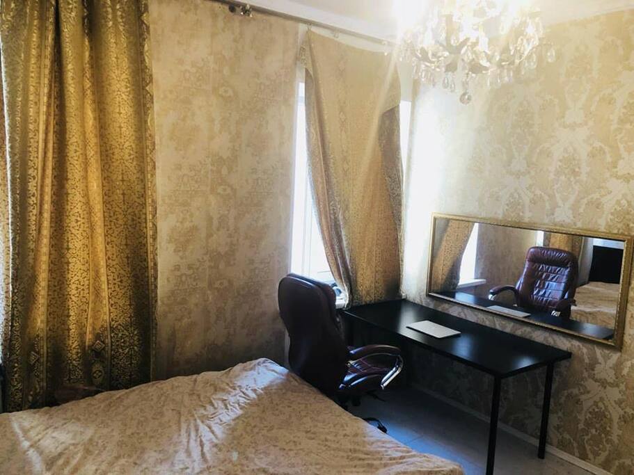 This is the second bedroom. There is a king size bed, a wardrobe and an office table