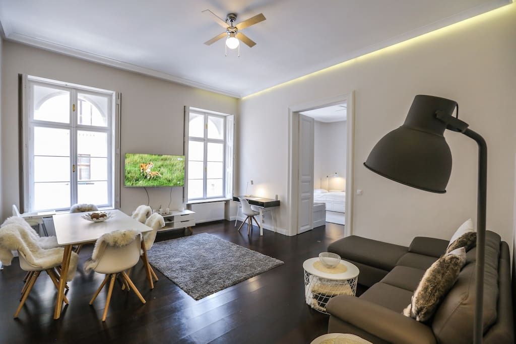 Spacious bright Living room, with large dining table, comfortable couch and big screen TV with local and international channels.