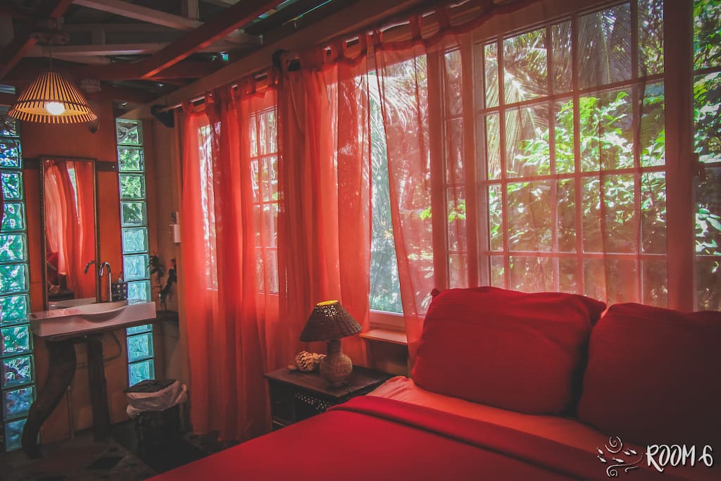 Bedroom surrounded by windows