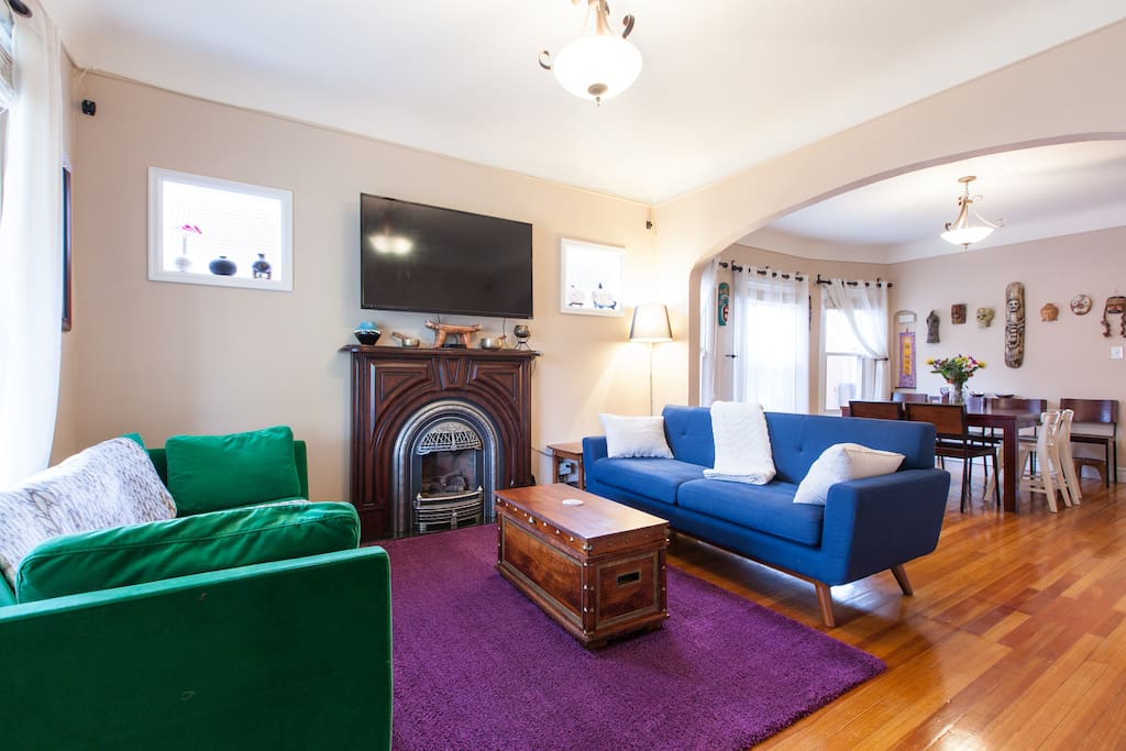 Living room with two comfy couches, a gas fireplace, and a 55" flat screen smart TV with Directv and Netflix