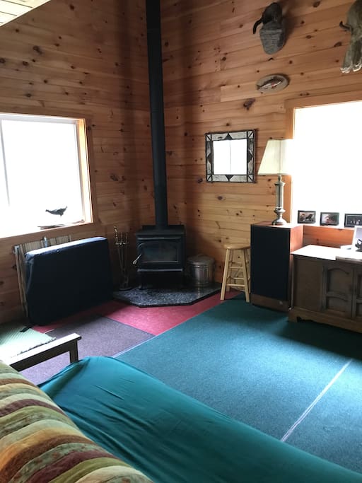 Open space with a wood burning stove, stereo, very chill.