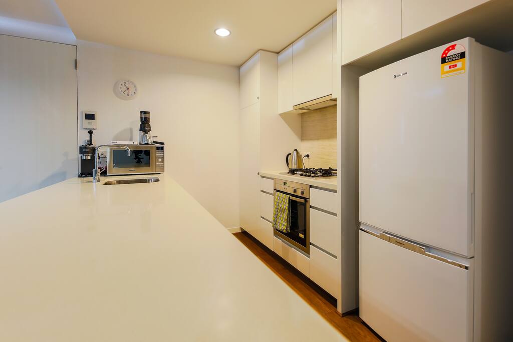 Gas cooktop and electric oven with full sized family fridge.