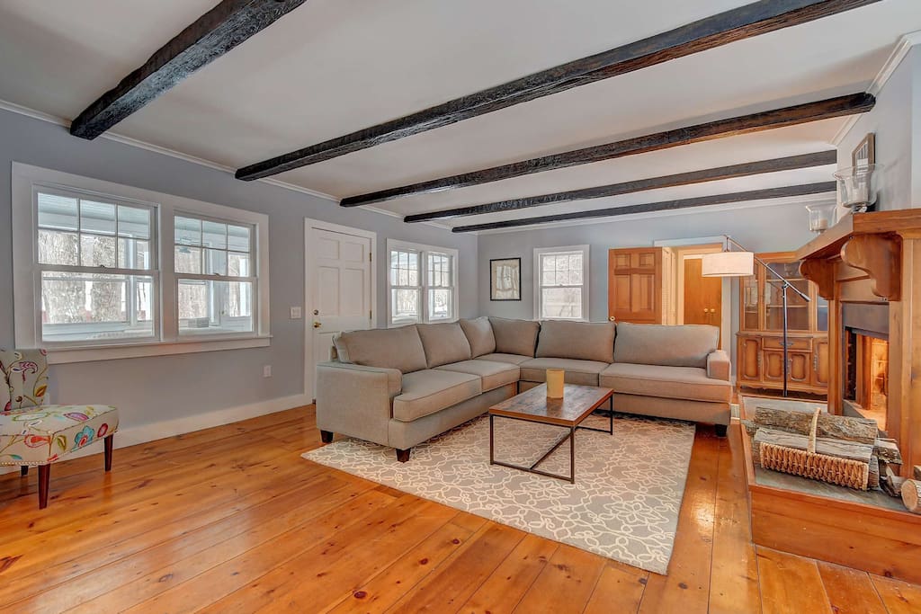 The living room’s open floor plan leads to the kitchen.