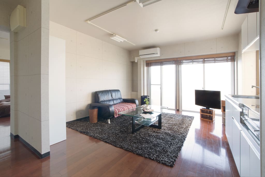 Bright living and dining area including television