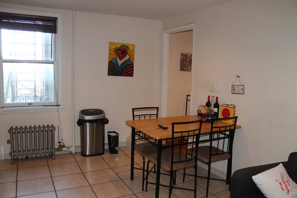 Living room and kitchen with couch and TV with Apple TV and Netflix