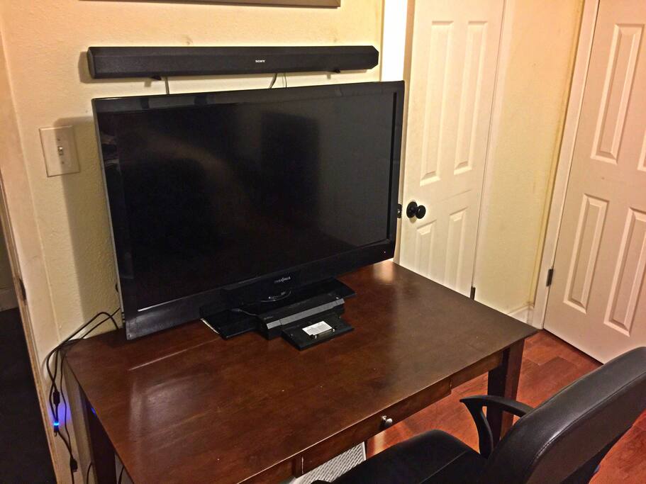 Mohageny desk with 43" HD tv with Dell laptop docking station and desk chair. Additional HDMI cords available for streaming. Sound bar too! Fast Wireless Internet!