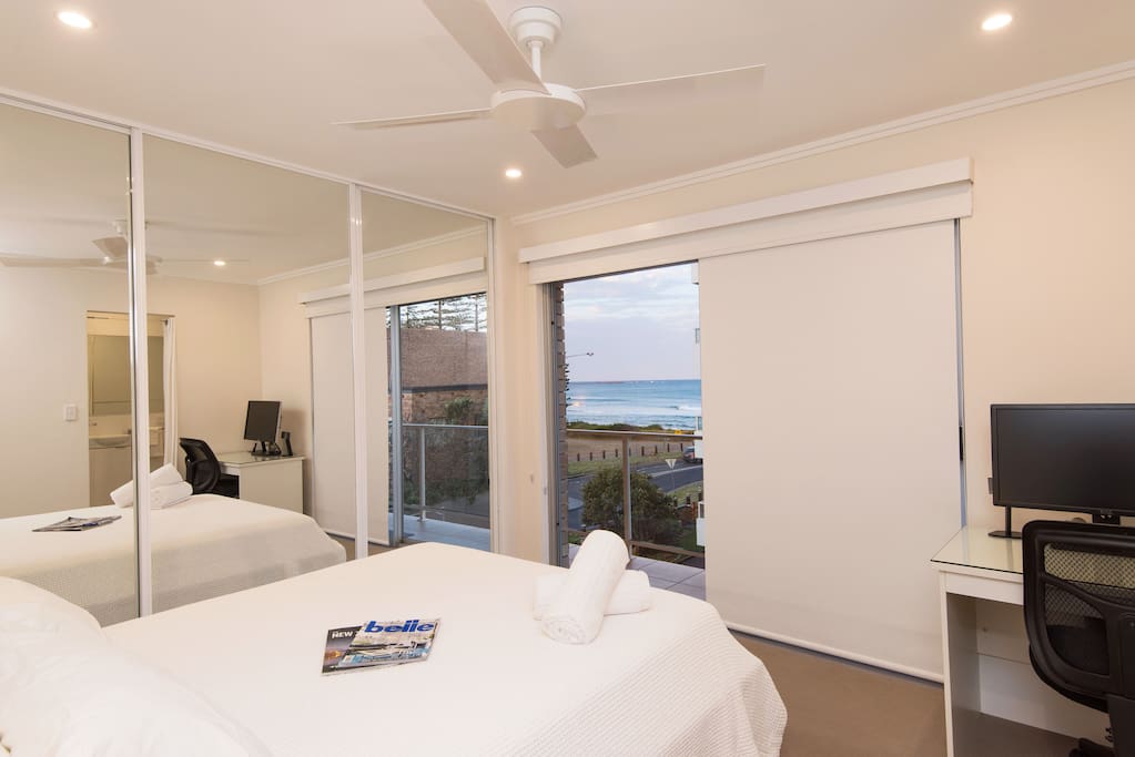 Main bedroom with ocean views and queen bed