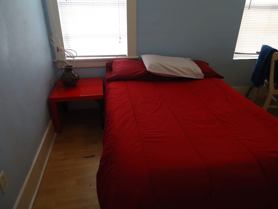 Another angle on the bed, with the bedside table more visible.