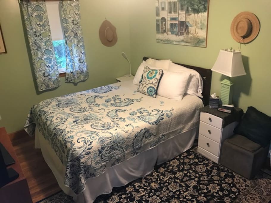 This comfortable queen bed has a padded mattress pad that sits atop a down alternative "feather" bed.