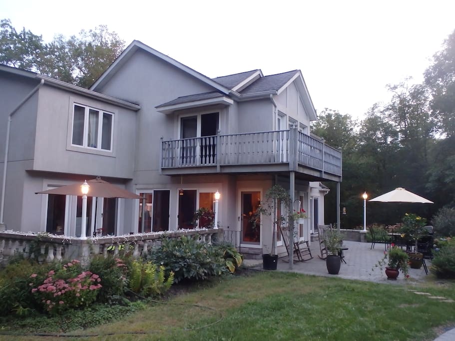 2 patios with tables and chairs right next to the pool. Great space for barbecuing.