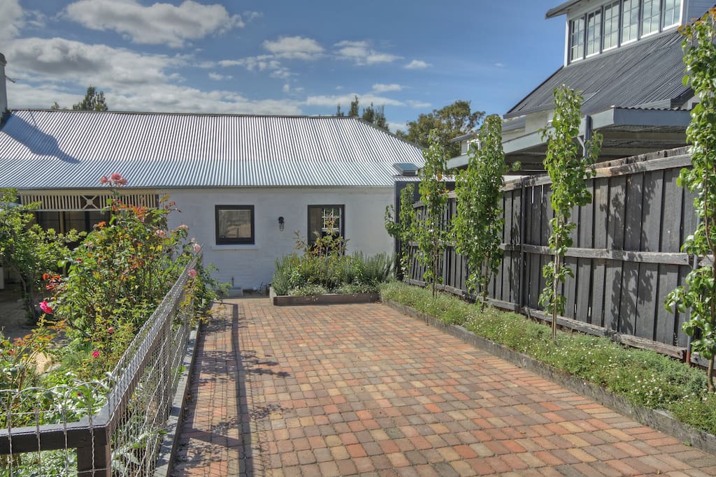 A secure and inviting entrance of herbs and roses.