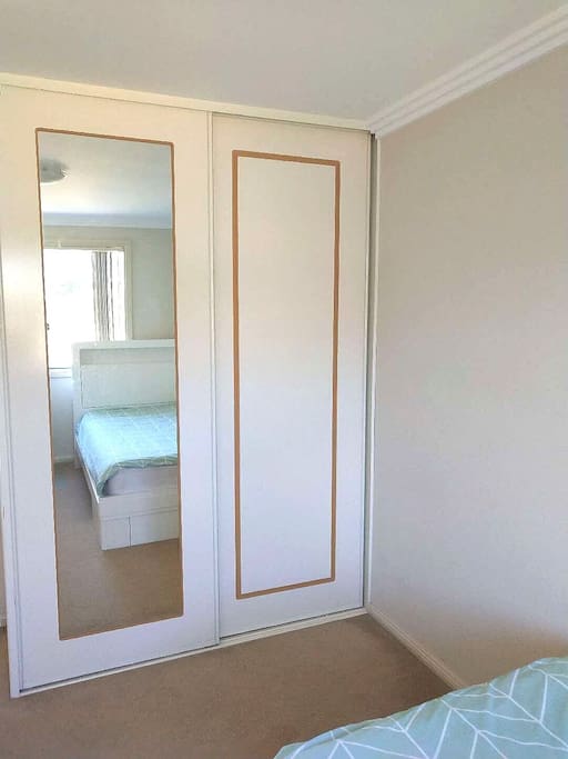 Wardrobe with mirror opposite the bed