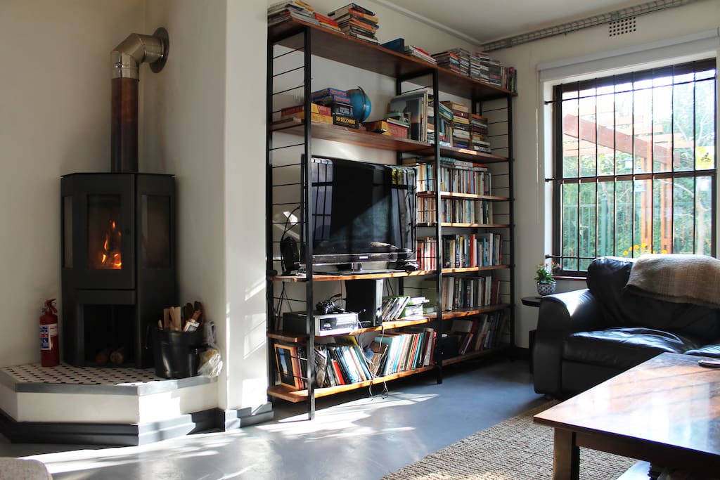 The living room, with lots of books and cozy fireplace for chilly winter evenings.