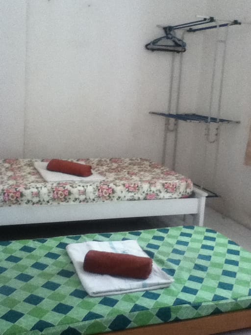 Twin bed with cloth rack.