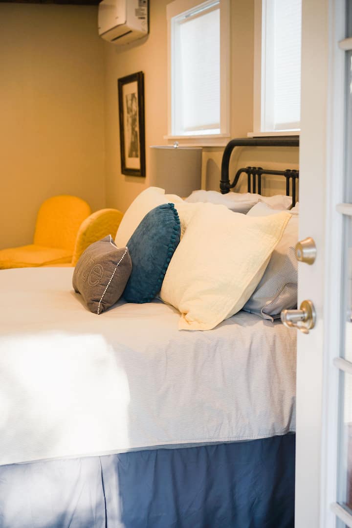 The primary bedroom includes a comfy queen-sized bed and sitting area. 