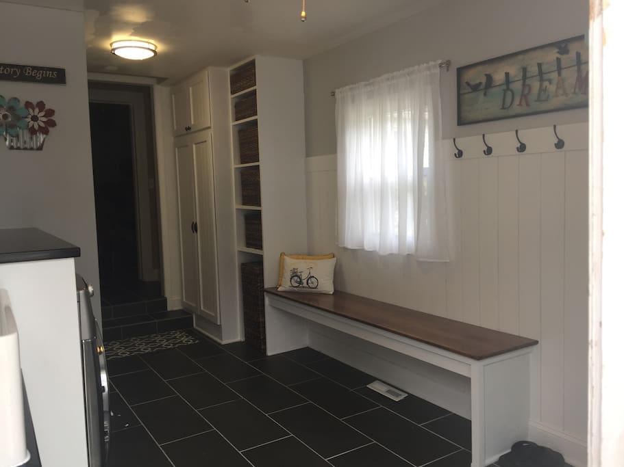 Entryway with ironing board and iron.