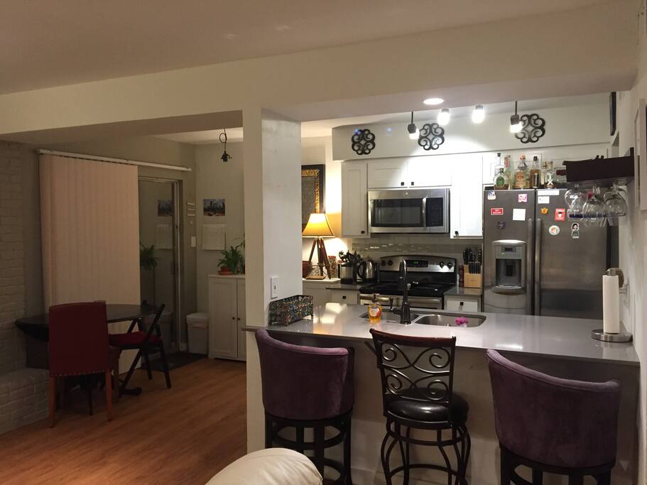 Kitchen, bar, and dining area. Table extends to seat four.