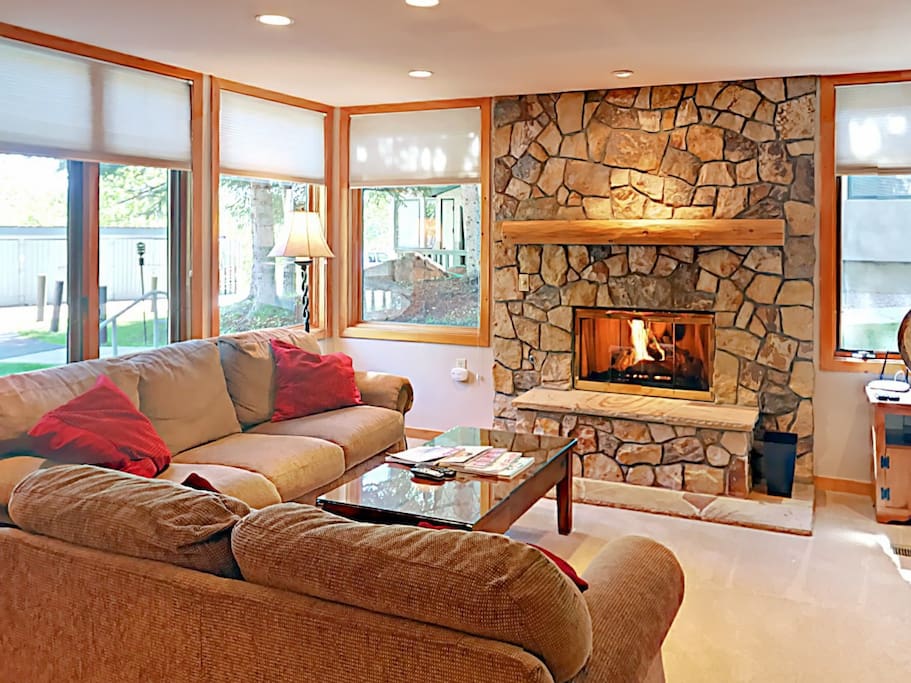 The inviting living area has seating for 7 around the glowing fireplace