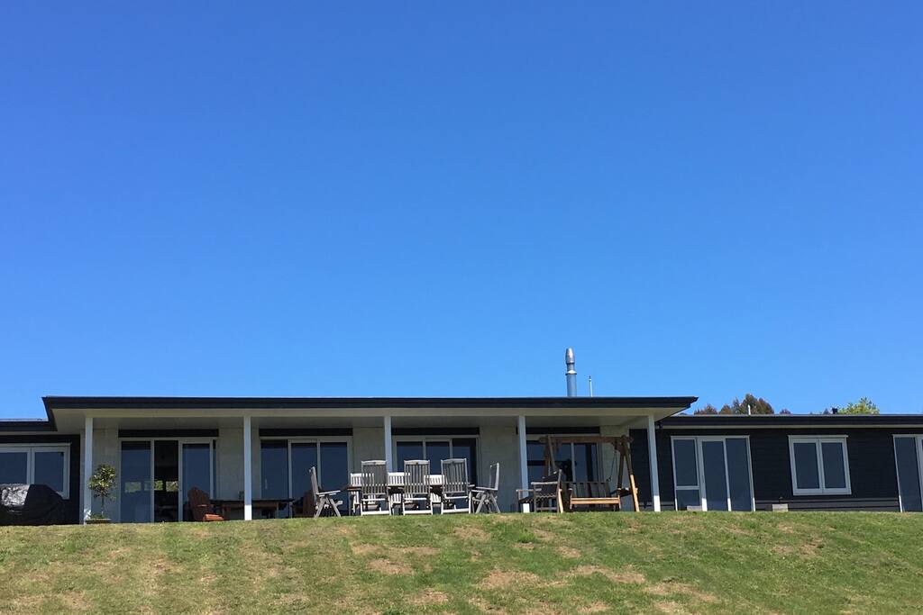 On our deck where you can sit and enjoy the lake view and at night see the lights of town looking magical .