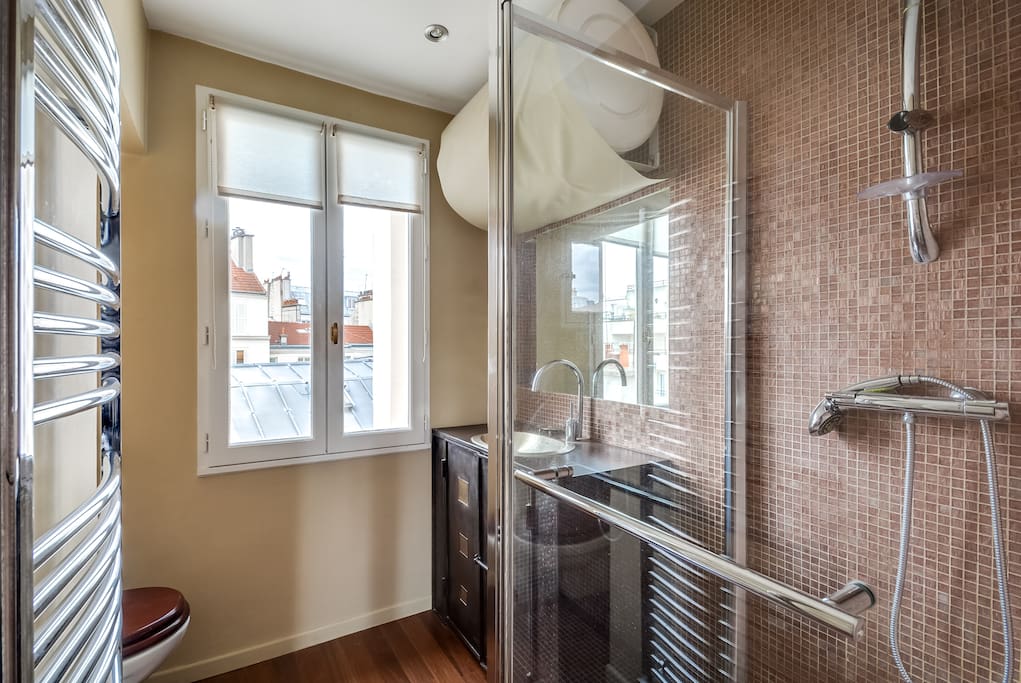 The luxurious bathroom with golden bisazza mosaic and a king size shower