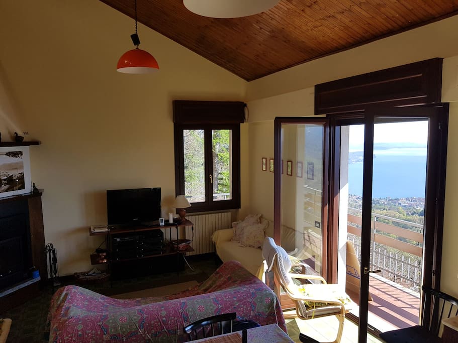 Living room with fireplace, tv and stunning view