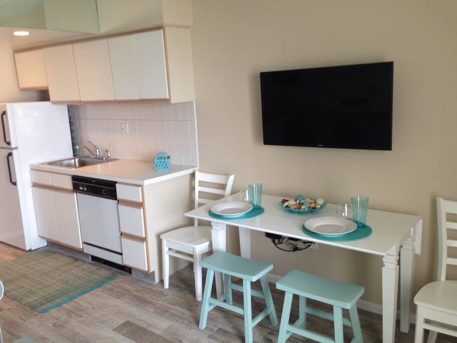 Table pulls out and seats 4. Kitchen is fully equipped with fridge, dishwasher, microwave and regular oven. Dishes, utensils and other essentials are included.