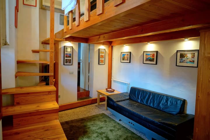 Comfortable living area has fold-out sofa bed downstairs, double bed upstairs on the loft.
