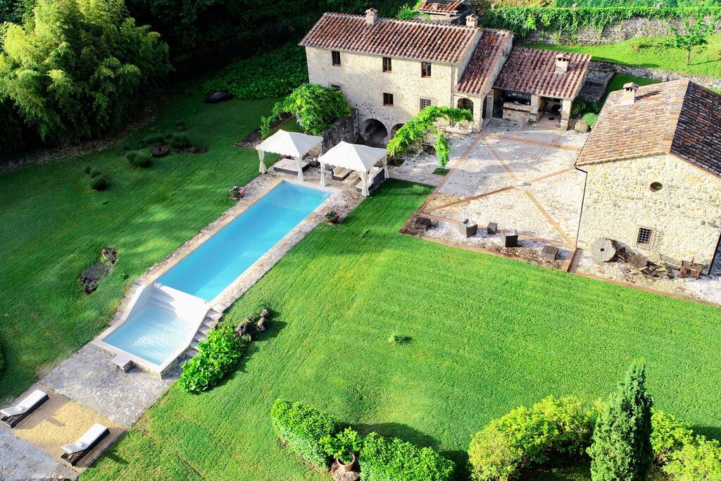 Mulino di Anqua's grand pool filled with fresh spring water. Overall picture from northwest